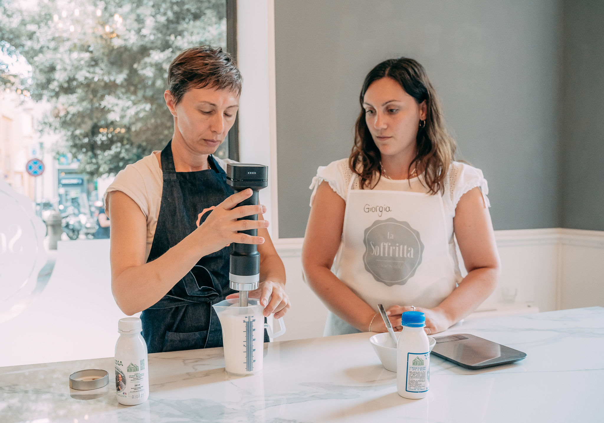 Due donne mescolano gli ingredienti del gelato durante la Cooking Class a La Soffritta di Bologna