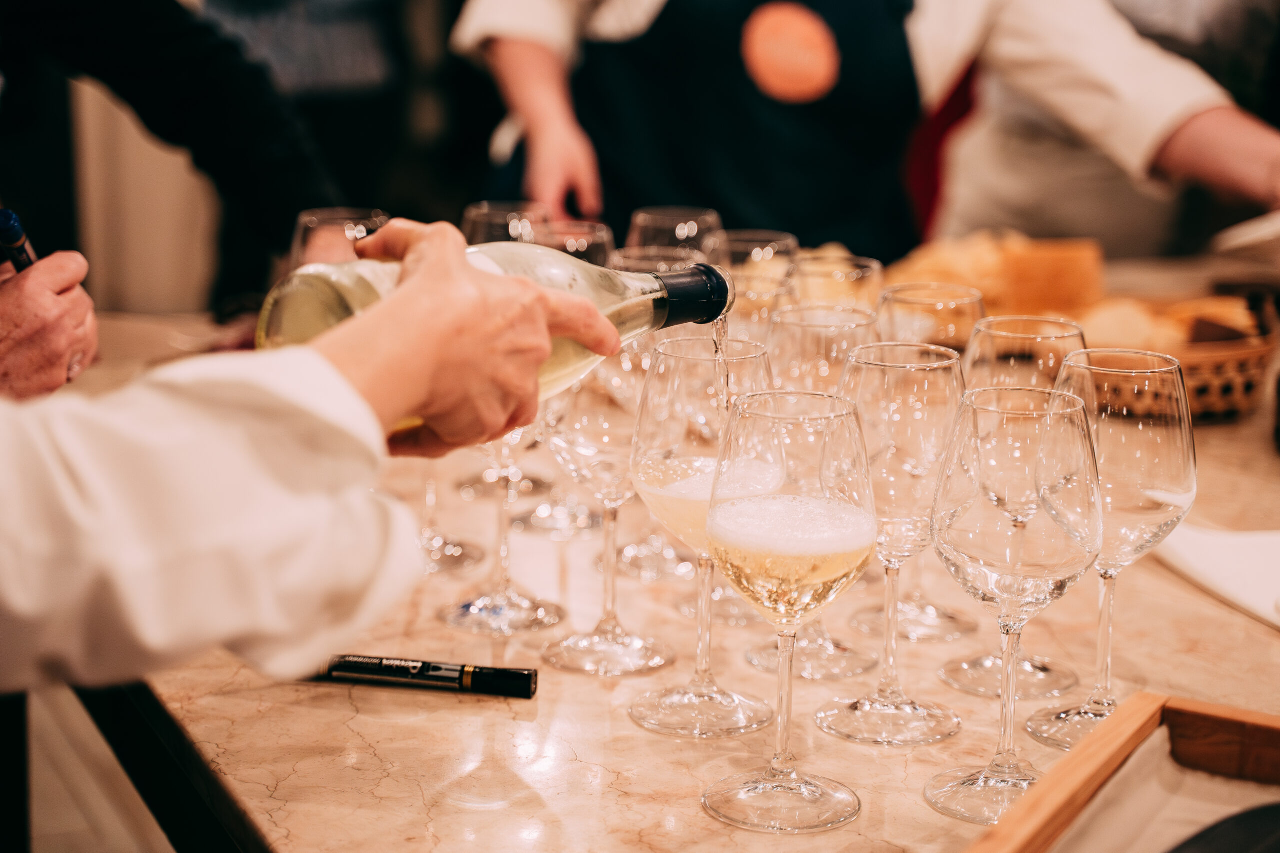 Prosecco servito nei calici durante un evento in cucina