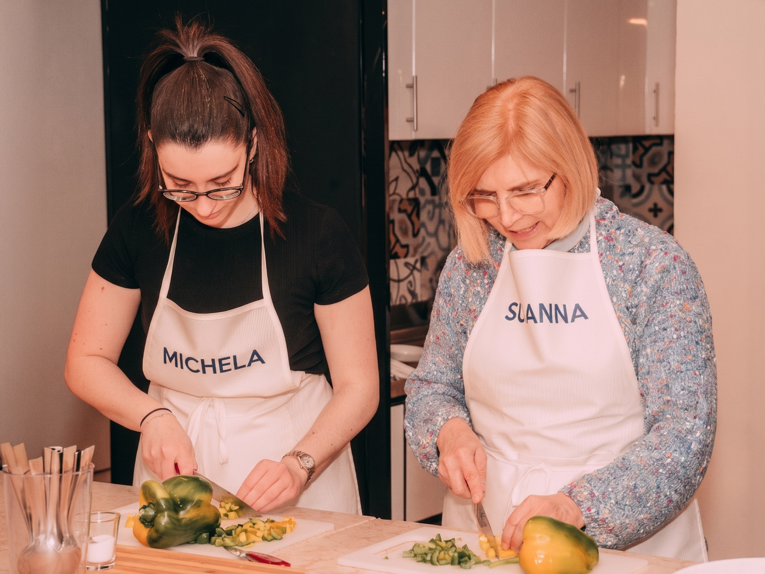Due colleghe tagliano le verdure fresche in due postazioni vicine