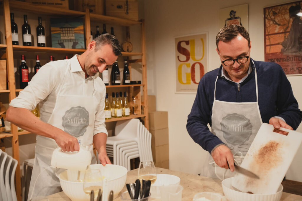 Two men preparing a Team Cooking of La Soffritta