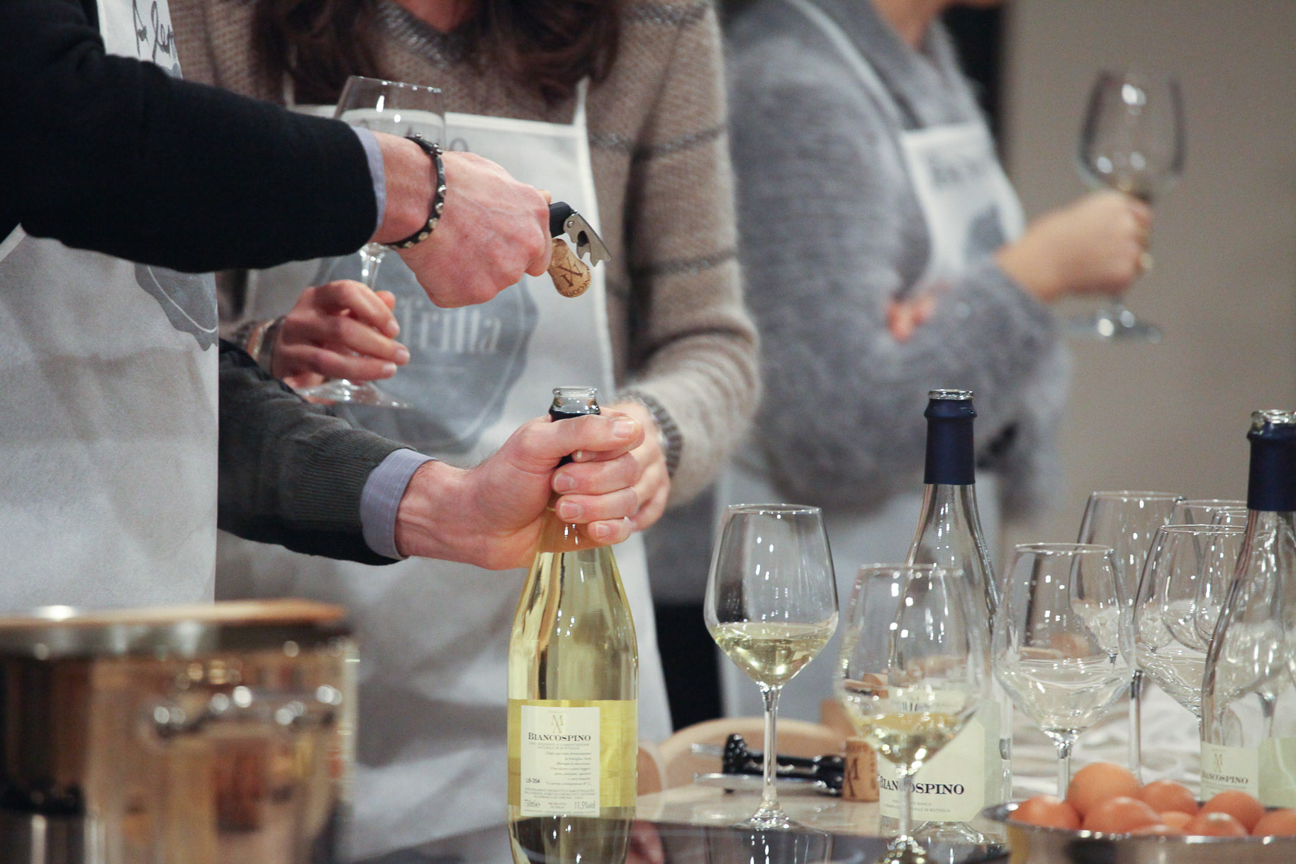 Mani stappano una calice di vino